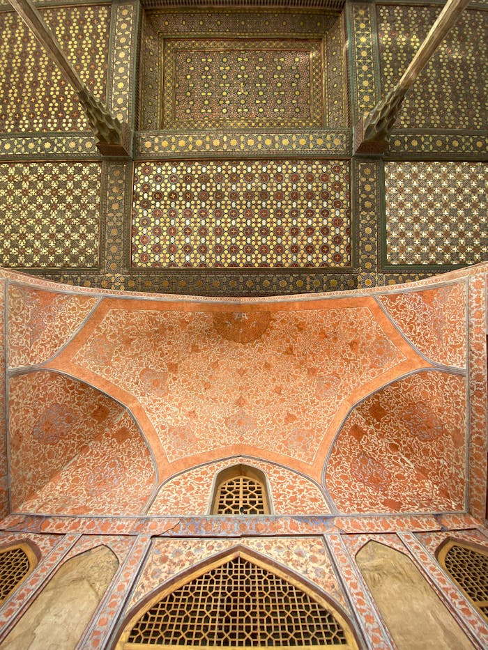 A detailed view of the ornate ceiling inside the Chehel Sotoun Palace in Isfahan, showcasing Persian art.